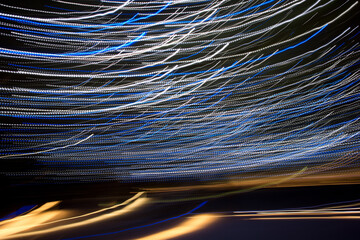 abstract light streaks background pattern against black 