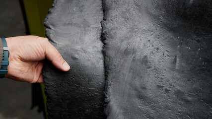 One of the first stages of production of rubber products at the plant. Close-up of raw material seam texture. Medium wholesale manufacturing technology