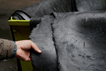 One of the first stages of production of rubber products at the plant. Close-up of raw material seam texture. Medium wholesale manufacturing technology