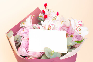 beautiful bouquet of Alstroemeria and purple roses with a card for text. Fresh, lush bouquet of colorful flowers