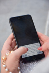 Close up young woman hands holding smartphone.