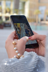 close up young woman hands holding smartphone and shopping online 