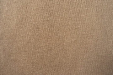 Fototapeta na wymiar Simple beige cotton jersey fabric from above