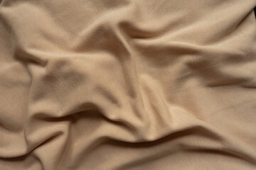 Draped simple beige cotton jersey fabric from above
