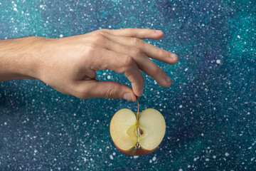 Man hand holding a slice of apple