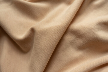 Fototapeta premium Light brown cotton jersey fabric in soft folds