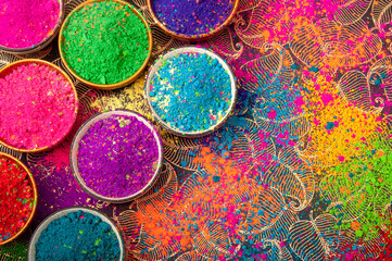 Happy Holi top view of colorful holi colors in bowls with Splash, Concept Indian color festival. 