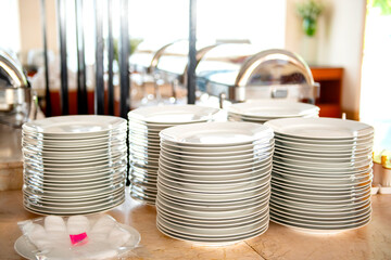The plates of food were stacked on top of the table, plastic gloves before picking up the plates