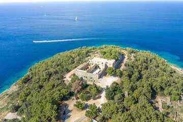 Fototapeta na wymiar Aerial drone shot of stone Fort George Croatia on top of hill in Adriatic sea on Vis Island in summer