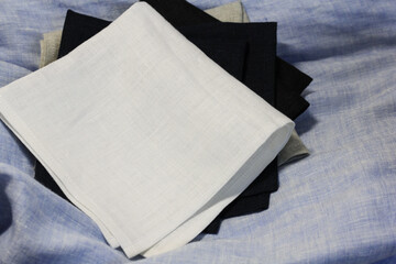 Linen napkins folded on a home tablecloth.
