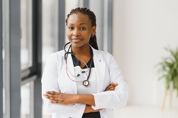 Portrait of female African American doctor standing in her office at clinic