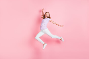 Fototapeta na wymiar Full length profile side photo of happy cheerful little girl raise hands isolated on pastel pink color background