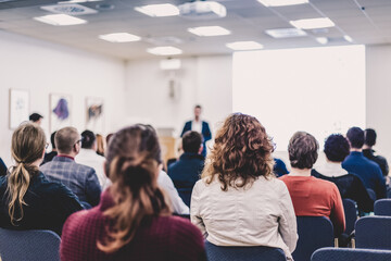 Speaker Giving a Talk at Business Meeting. Audience in the conference hall. Business and Entrepreneurship. - obrazy, fototapety, plakaty