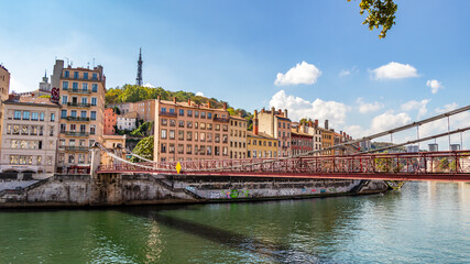 Fototapeta na wymiar Old Lyon and Fourviere hill as seen from the Saint Vincent footbridge on a sunny day