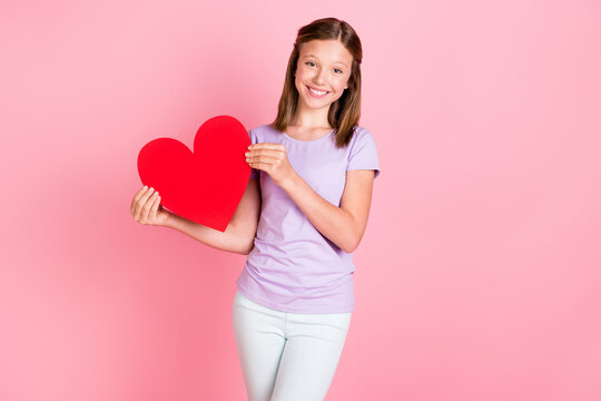 Photo of nice lovely happy little girl hold hands big heart figure smile good mood isolated on pink color background