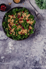 Healthy raw kale and quinoa salad with cranberry and pine nut.