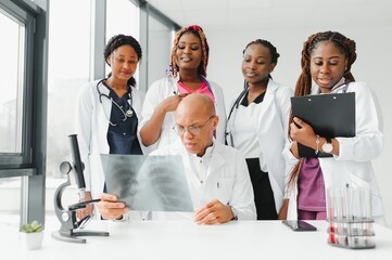 confident african medical doctor and colleagues portrait in hospital