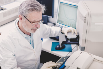 Life science researcher performing a genotyping testing which enables personalized medicine. PM is a medical model that proposes the customization of healthcare.