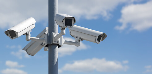 Four CCTV security cameras on a pole