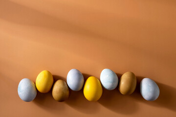 Naturally dyed easter eggs on beige background. Eco concept. Organic natural easter concept.