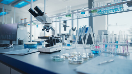 Modern Medical Research Laboratory with Microscope and Test Tubes with Biochemicals on the Desk....