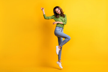 Fototapeta na wymiar Full size photo of cheerful lovely young woman jump up wear green turtleneck isolated on shine yellow color background