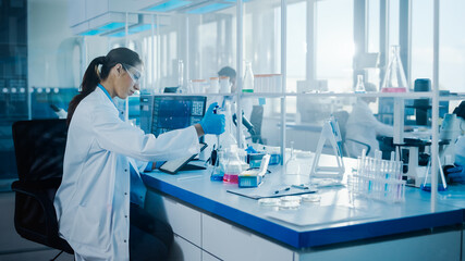 Modern Medical Research Laboratory: Female Scientists Working with Pipette, Using Digital Tablet,...