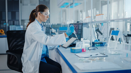 Modern Medical Research Laboratory: Female Scientist Working with Micro Pipette, Using Digital...