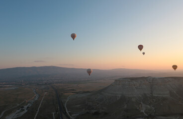 aerial view of a group of  hot air balloons  flying at down in cappadocia