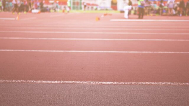 Javelin throwing competition in the stadium. The focus is on the front. Low angle.