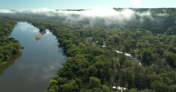 Clouds and a fog bank obscure the hills along the Wisconsin River during an autumn morning near Prairie du Chien in Wisconsin