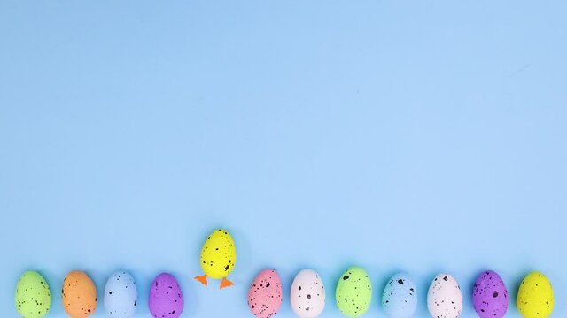 Moving easter eggs on bottom of blue theme and two eggs with legs step out. Stop motion