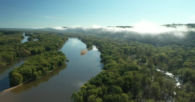 Clouds and a fog bank obscure the hills along the Wisconsin River during an autumn morning near Prairie du Chien in Wisconsin