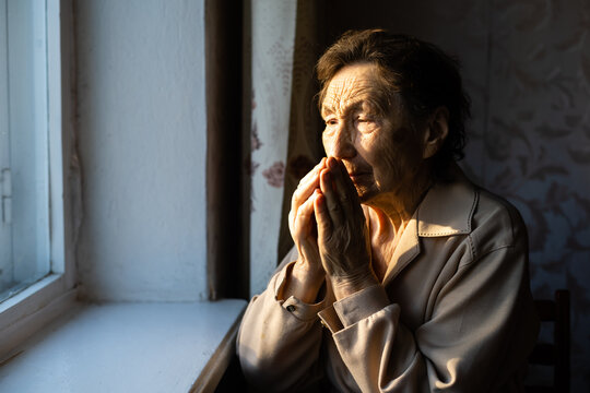 Very Old Woman Is Praying In Her Country Style Kitchen