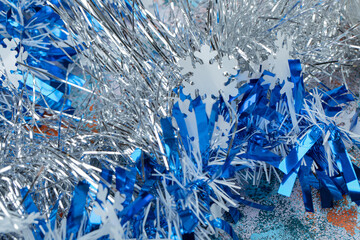 Christmas blue tinsel on colorful background