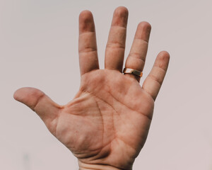 open hand ring white sky background