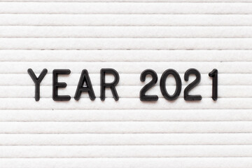 Black color letter in word year 2021 on white felt board background