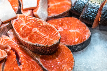 steaks of red fish on ice in a supermarket