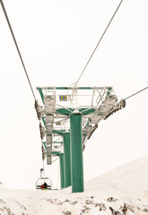 green structure of the telecavina in the ski center of the snowy mountain