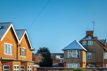 Houses roofs covered with winter snow in england uk