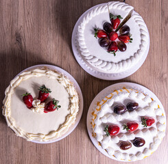 Strawberry and grape cake wooden background