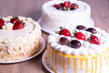 Strawberry and grape cake wooden background