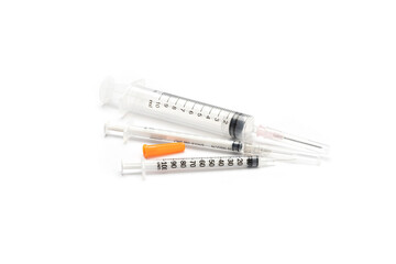 Obraz premium Multiple sizes of syringes are placed on white background. Isolated.