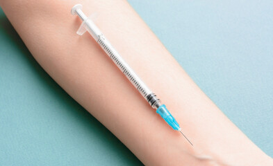 Syringe on womans hand. Coronavirus and flu vaccine concept.