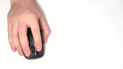 Hand with Wireless Computer Mouse Moves and Clicks. Copy Space. Top view shot. Close-up. White...