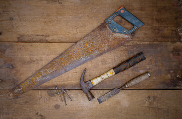 Hammer saw and chisel Collection of woodworking old handtools on a rough workbench wooden