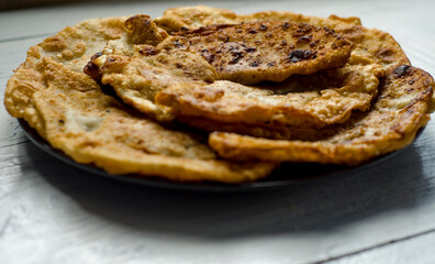 Fried flatbread with meat filling. Known in Asia as chebureks.