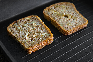 A grain bread on a grill pan. Homecooking during the quarantine time. 