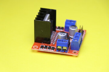 Motor driver used in interface between motor and control circuits used to make electronic projects on yellow background. Driver for stepper motor
