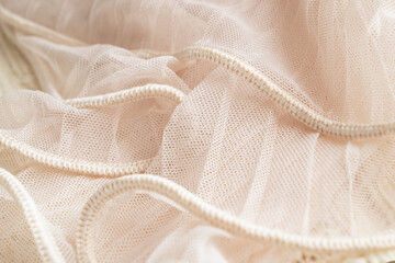 Ivory colored tulle fabric texture. Textile background